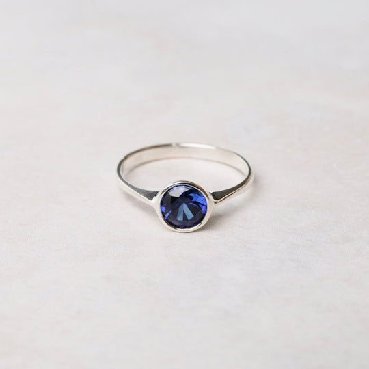 RNG Sterling Silver Ring with 6mm Round Bezel Set Synthetic Sapphire